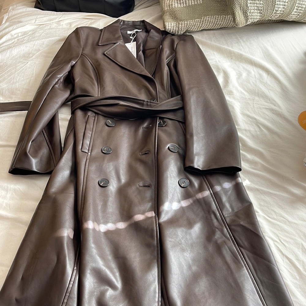 Brand new faux leather trench coat. Would fit a medium too.